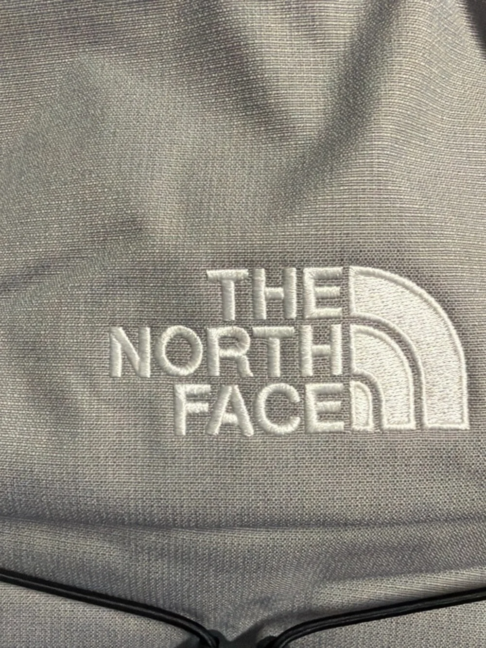 The North Face Light Gray and Black Backpack with Bungee Front